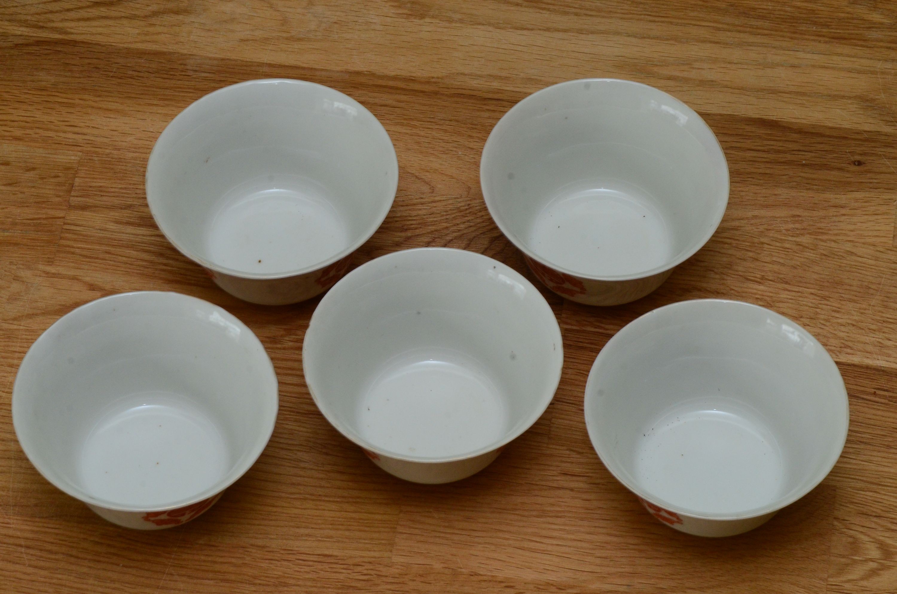 A set of five Chinese teabowls, covers and stands and a similar 'dragon' vase, 23cm